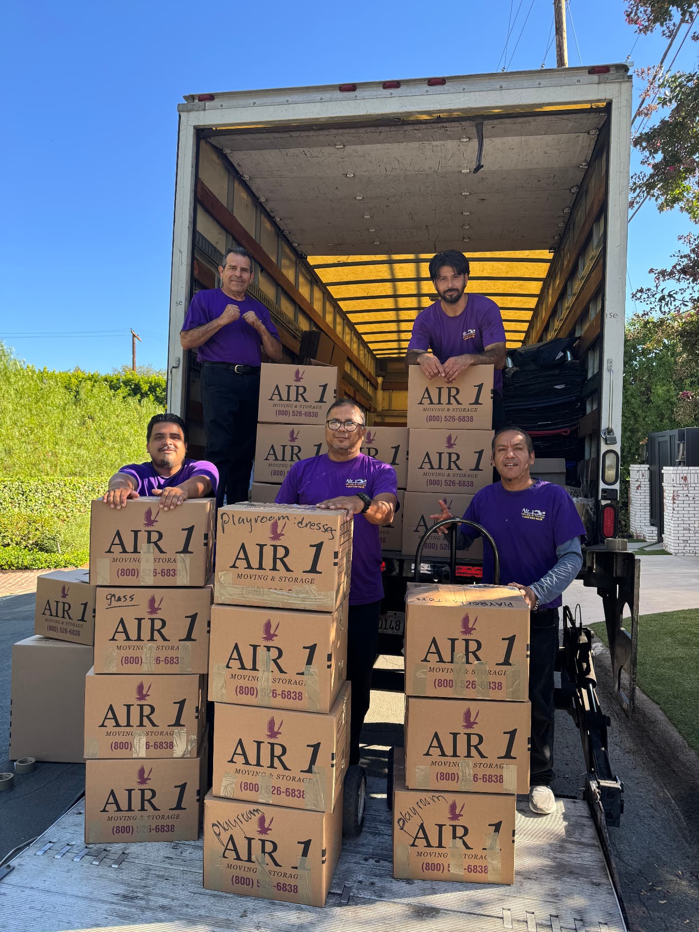 Air1 Moving team with packed boxes inside moving truck for California relocation
